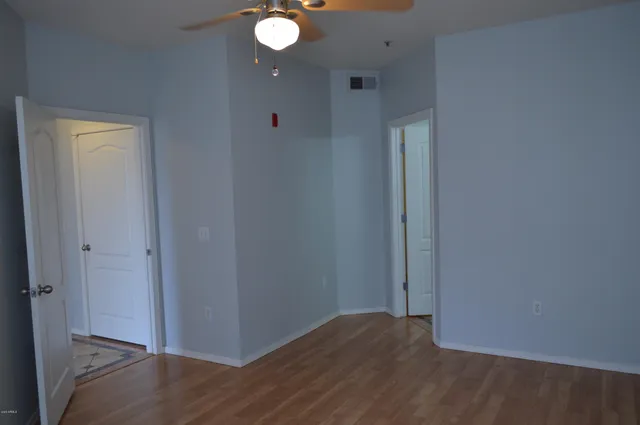 a view of hallway with wooden floor