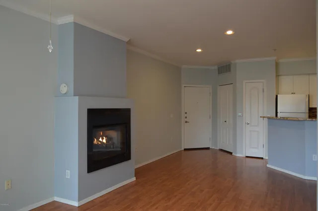 a view of an empty room and a fireplace