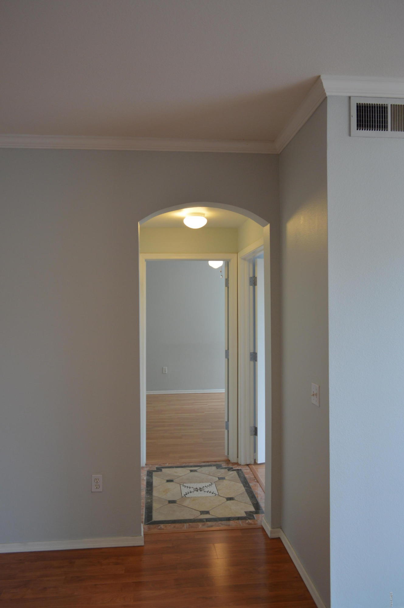 1701 East Colter Street, Unit 308 Phoenix, AZ 85016 - Photo 28 of 50 an empty room with wooden floor and a door