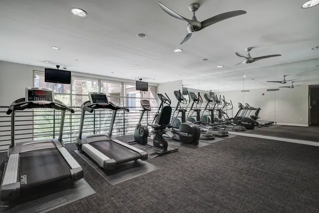 a room with gym equipment and mirrors