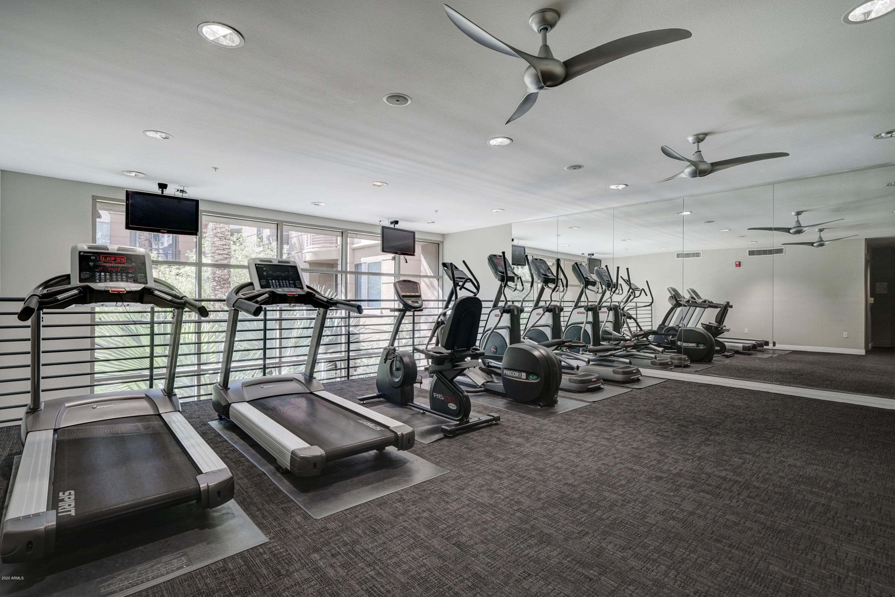 1701 East Colter Street, Unit 308 Phoenix, AZ 85016 - Photo 34 of 50 a room with gym equipment and mirrors