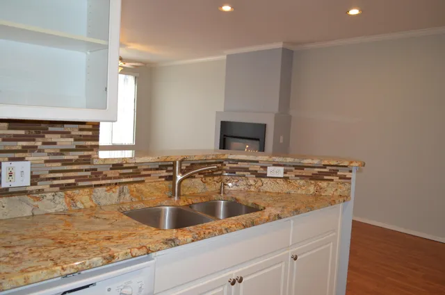a kitchen with a sink and a stove top oven