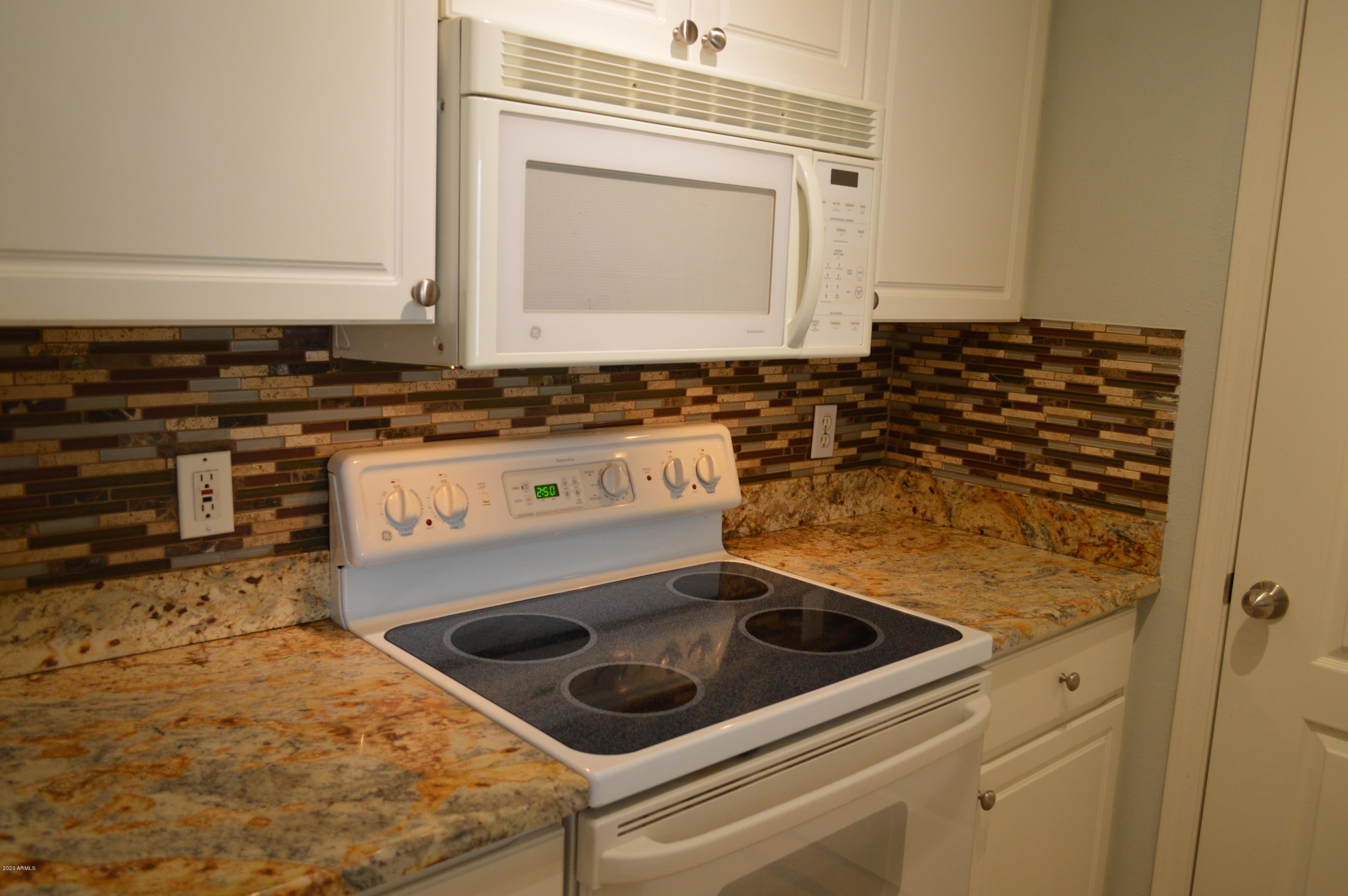 1701 East Colter Street, Unit 308 Phoenix, AZ 85016 - Photo 7 of 50 a kitchen with a stove and a microwave
