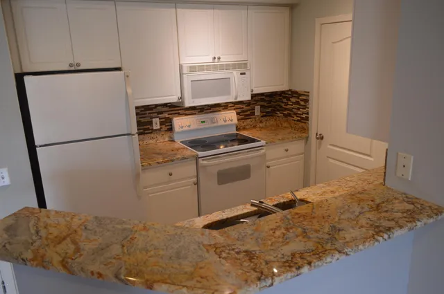 a kitchen with a stove and a refrigerator