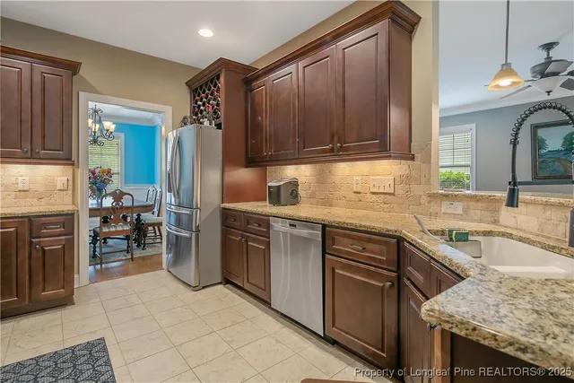 a kitchen with cabinets and stainless steel appliances