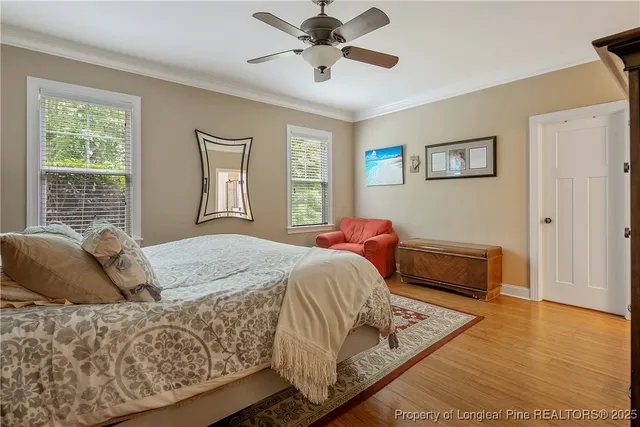 a bedroom with a bed and wooden floor
