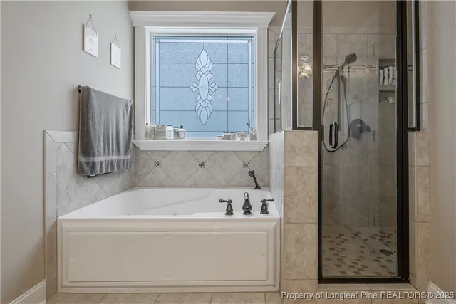 a bathroom with shower and bathtub