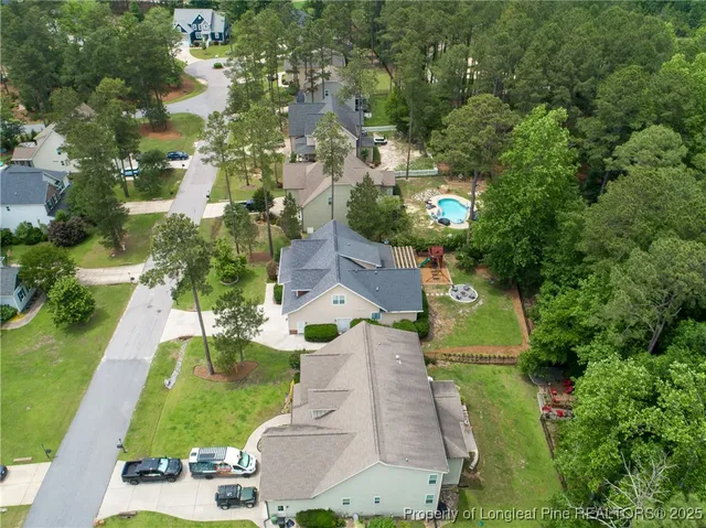 an aerial view of residential houses with outdoor space and street view