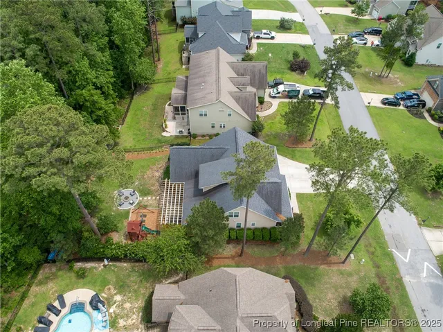 an aerial view of a house with garden space and street view