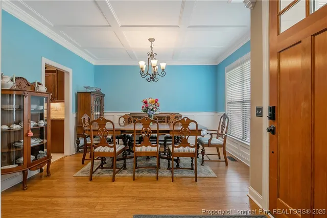 a view of a dining room with furniture and chandelier