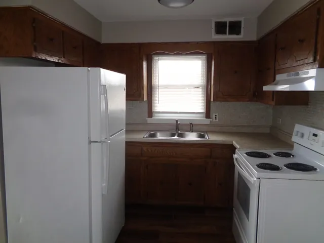 a kitchen with stainless steel appliances a sink stove and refrigerator