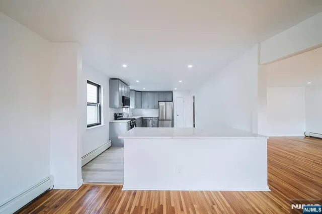 a kitchen with stainless steel appliances granite countertop a refrigerator sink and cabinets