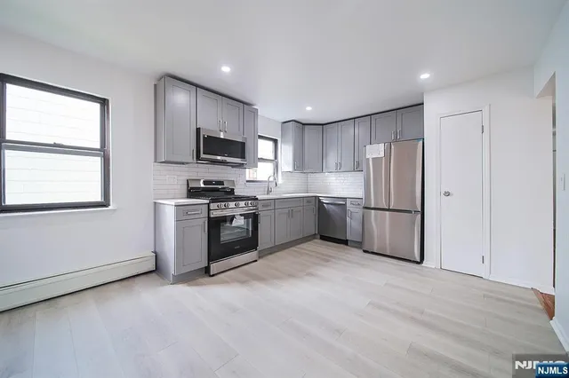 a kitchen with a refrigerator stove and microwave