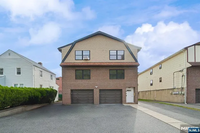 a view of a house with a yard and garage