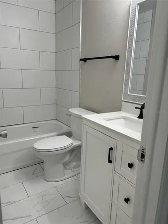 a bathroom with a toilet a sink and shower