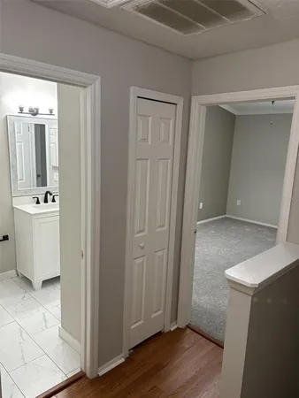 a view of bathroom with a sink mirror and window