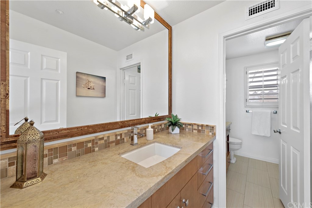 43 Cassis Dana Point, CA 92629 - Photo 17 of 41 a bathroom with a granite countertop sink and a mirror