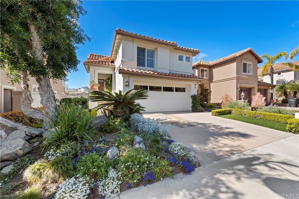 43 Cassis Dana Point, CA 92629 - Photo 2 of 41 a front view of a house with a yard and garage
