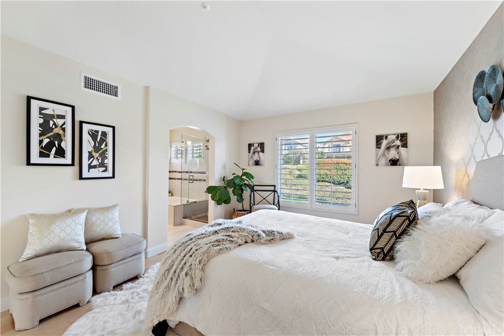 43 Cassis Dana Point, CA 92629 - Photo 9 of 41 a bedroom with a bed a couch and a window