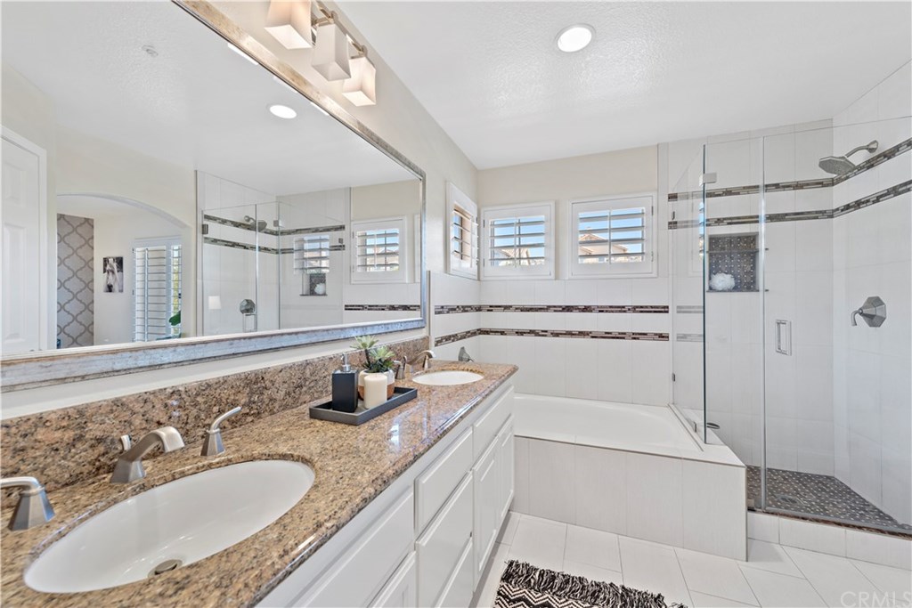 43 Cassis Dana Point, CA 92629 - Photo 10 of 41 a bathroom with a granite countertop sink mirror and shower