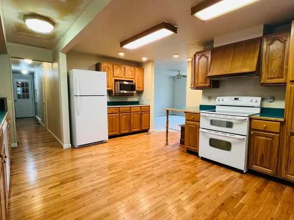 a kitchen with stainless steel appliances a stove a refrigerator and a sink