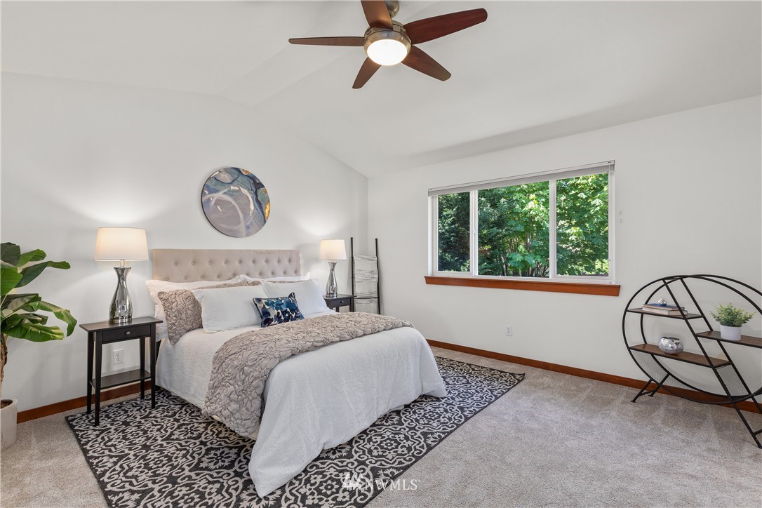 3603 222nd Place Southeast Bothell, WA 98021 - Photo 23 of 40 a bedroom with a bed a dresser next to a window