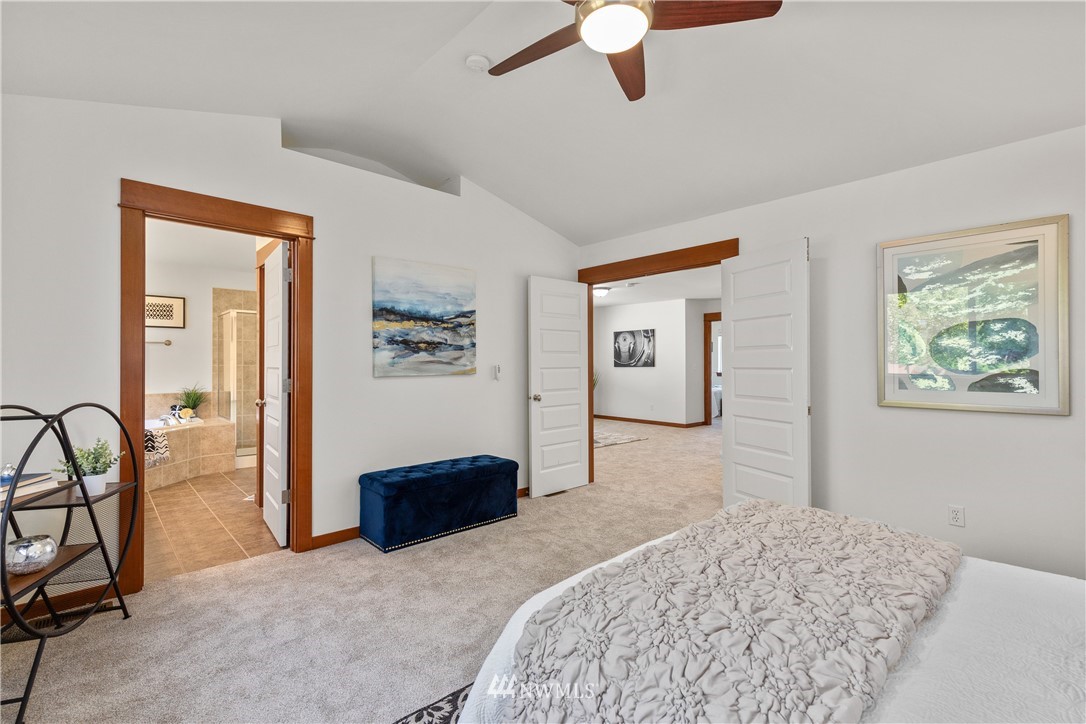 3603 222nd Place Southeast Bothell, WA 98021 - Photo 24 of 40 a bedroom with a bed and a chandelier