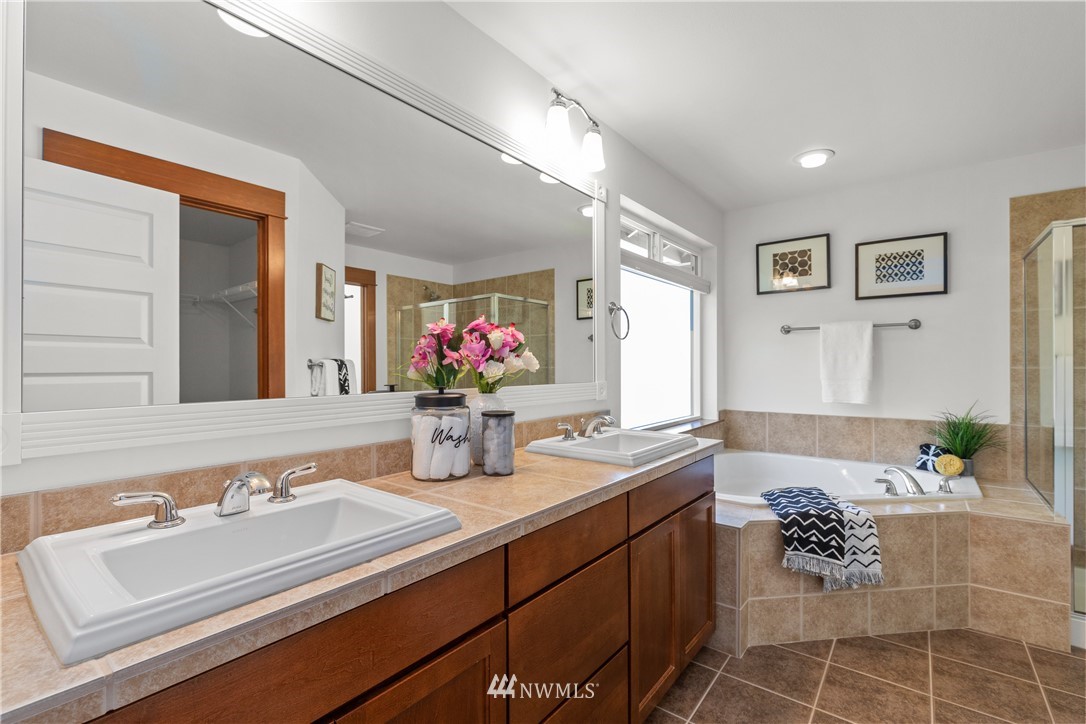 3603 222nd Place Southeast Bothell, WA 98021 - Photo 26 of 40 a bathroom with a granite countertop bathtub sink vanity mirror and