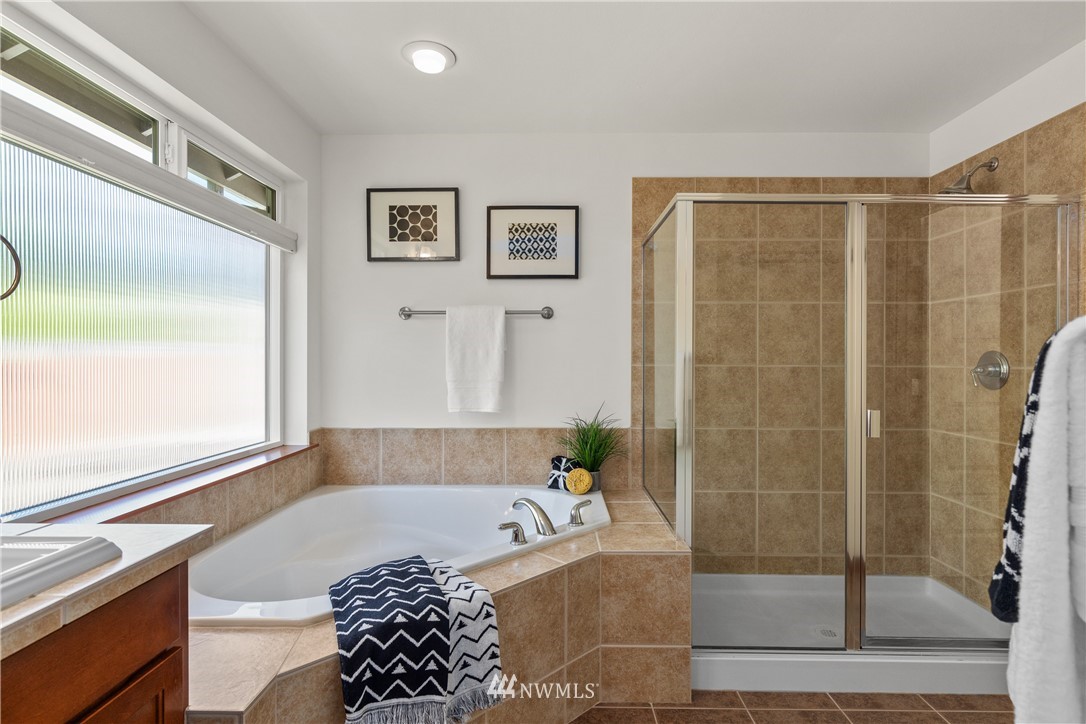 3603 222nd Place Southeast Bothell, WA 98021 - Photo 27 of 40 a bathroom with a bathtub and a shower