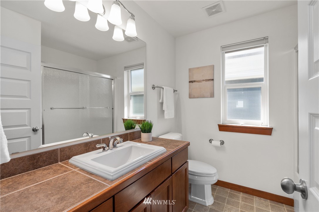 3603 222nd Place Southeast Bothell, WA 98021 - Photo 32 of 40 a bathroom with a sink a toilet and mirror