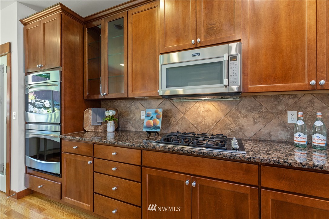 3603 222nd Place Southeast Bothell, WA 98021 - Photo 9 of 40 a kitchen with granite countertop cabinets stainless steel appliances and a counter space