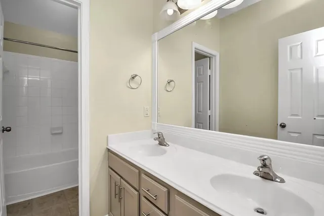 a bathroom with a tub a sink and a window