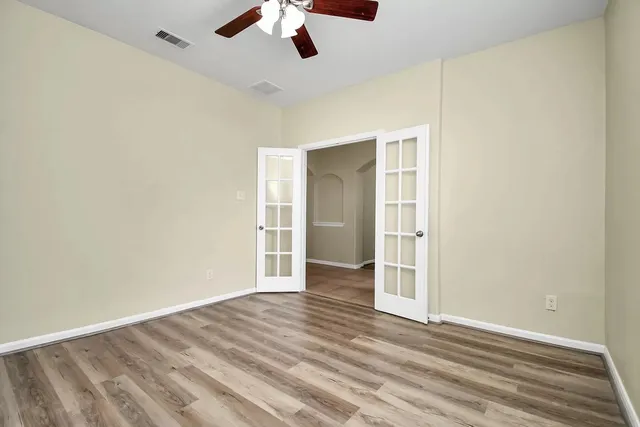 an empty room with a empty space and a ceiling fan