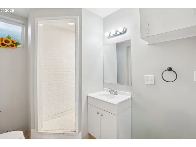 a bathroom with a sink a mirror and a light fixture