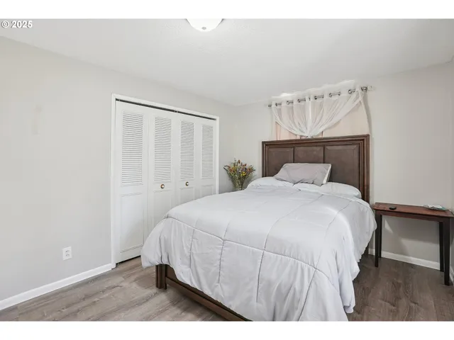 a bedroom with a bed and a night stand