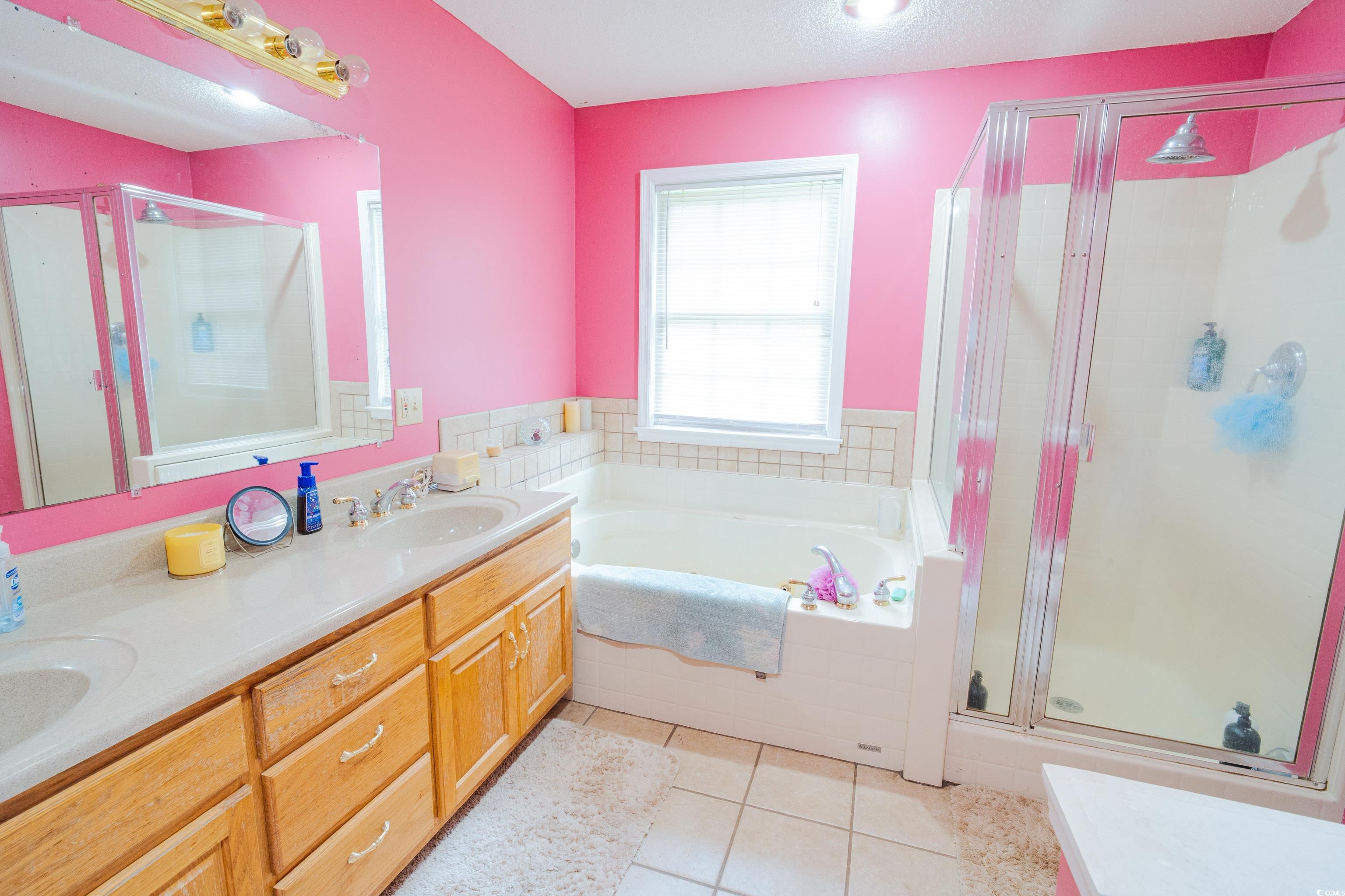 1582 Santee Road Andrews, SC 29510 - Photo 23 of 40 Full bath featuring a stall shower, a bath, light tile patterned flooring, and a textured ceiling