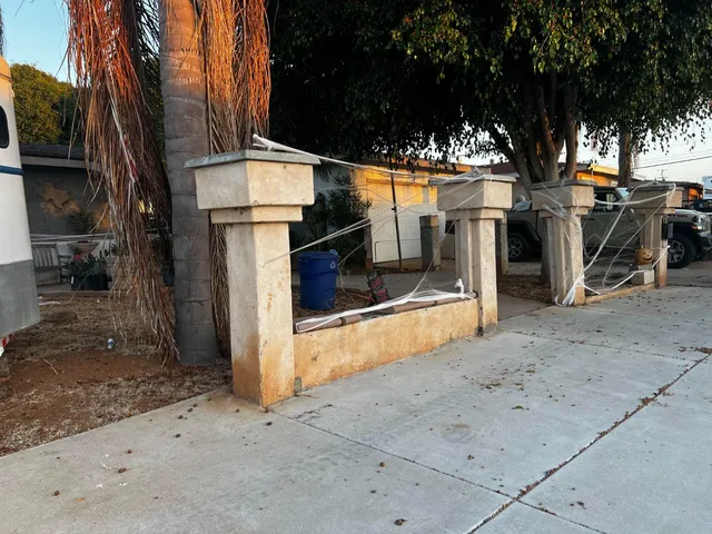 a view of a street with wooden fence