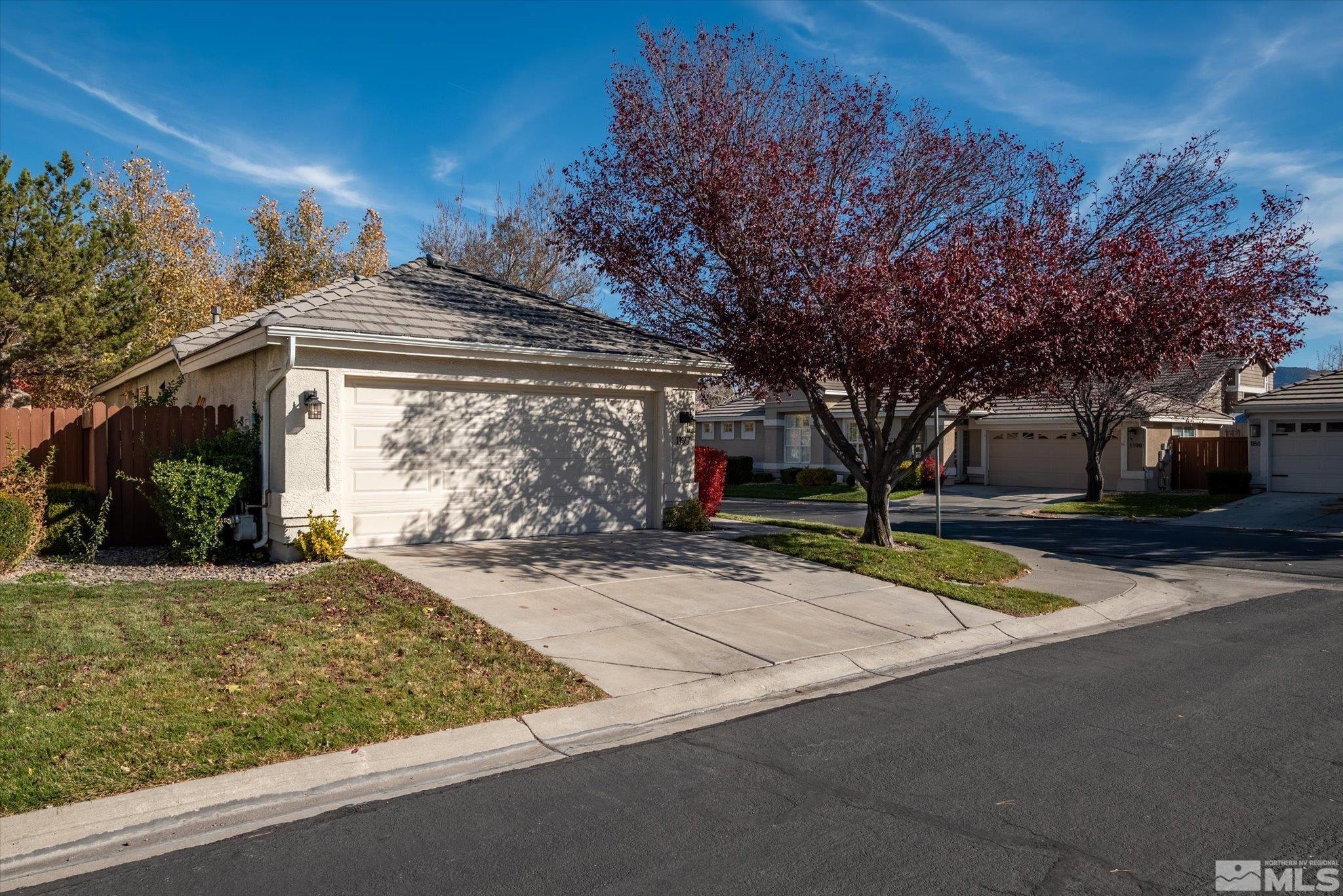 1197 Tule Drive Reno, NV 89521 - Photo 1 of 30 a front view of a house with garden