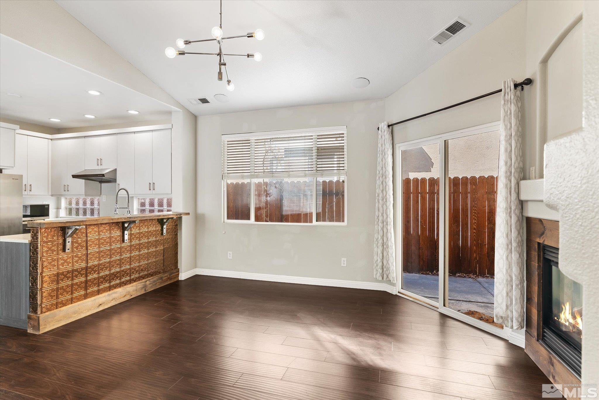 1197 Tule Drive Reno, NV 89521 - Photo 16 of 30 a view of an empty room with wooden floor and a window
