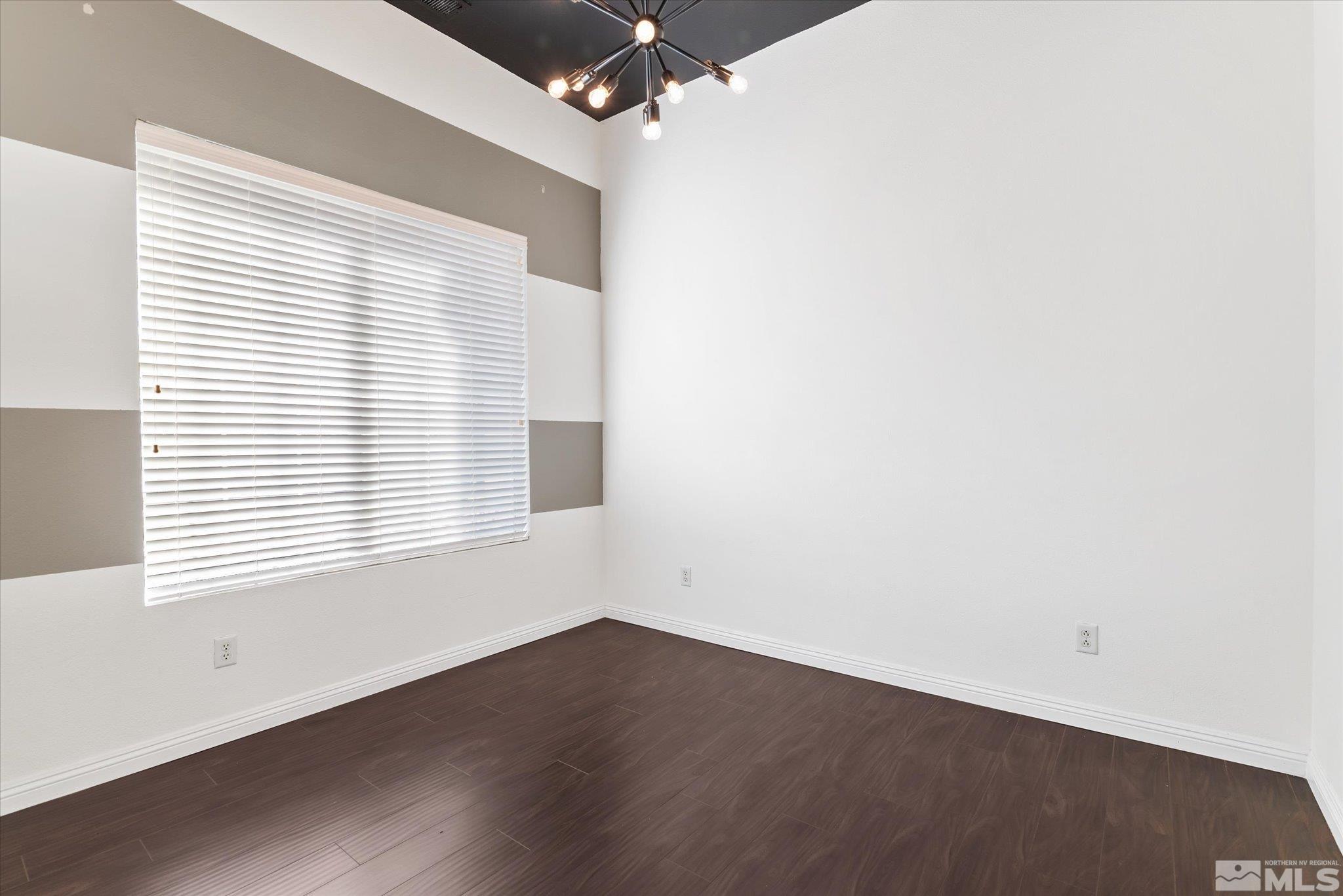 1197 Tule Drive Reno, NV 89521 - Photo 25 of 30 an empty room with wooden floor and windows