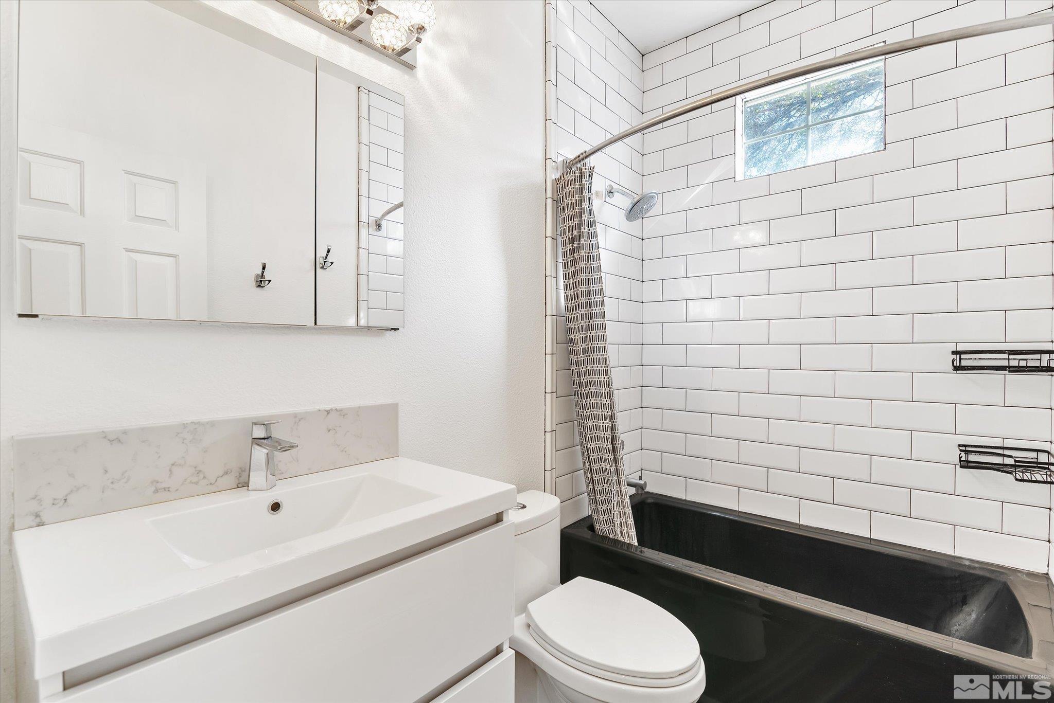 1197 Tule Drive Reno, NV 89521 - Photo 27 of 30 a bathroom with a sink a toilet and shower