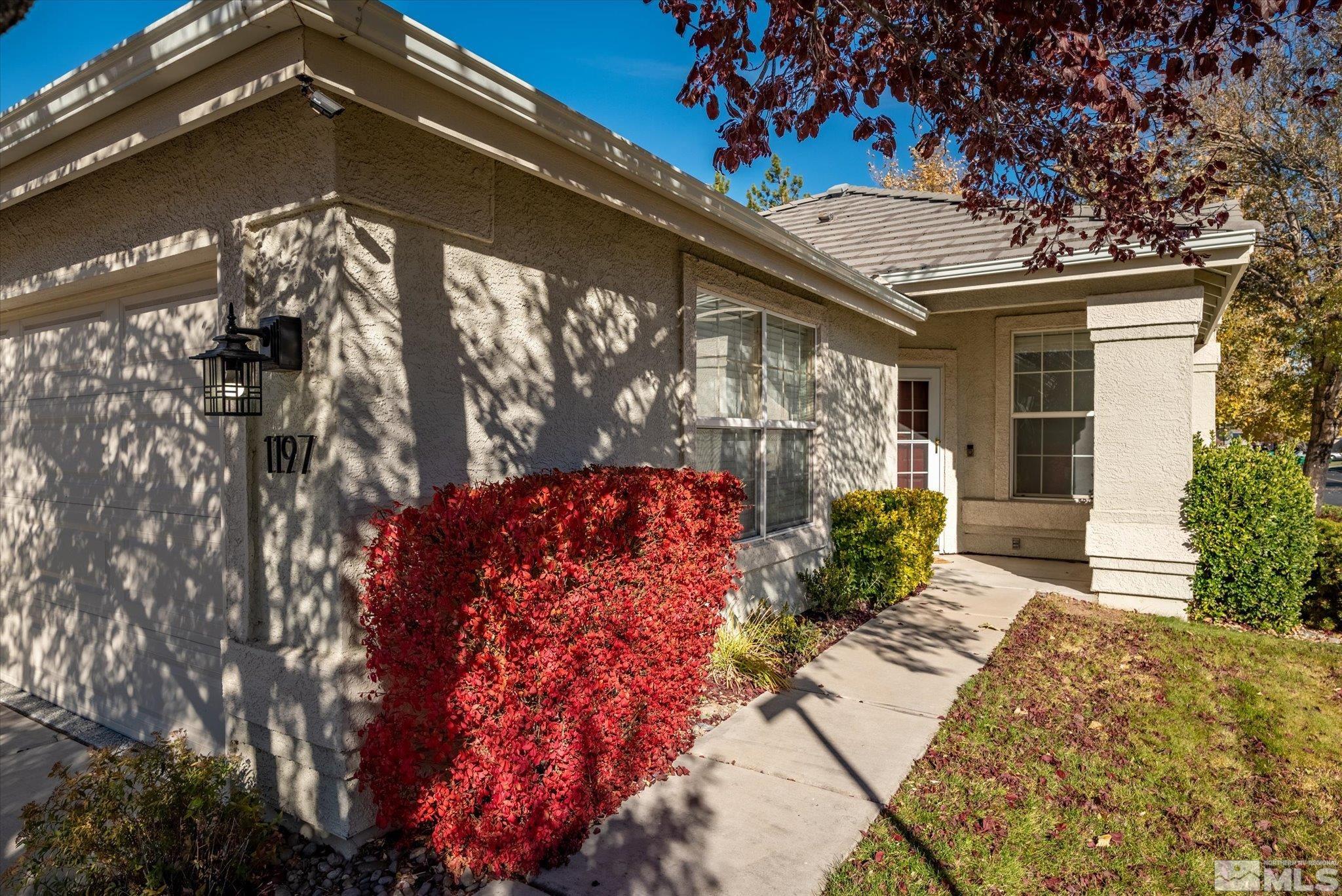 1197 Tule Drive Reno, NV 89521 - Photo 4 of 30 a front view of a house with garden