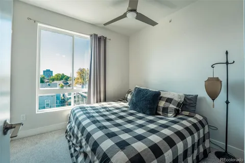 a bedroom with a bed and window