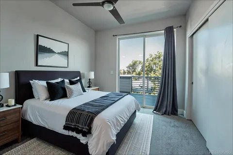 a bed sitting in a bedroom next to a window