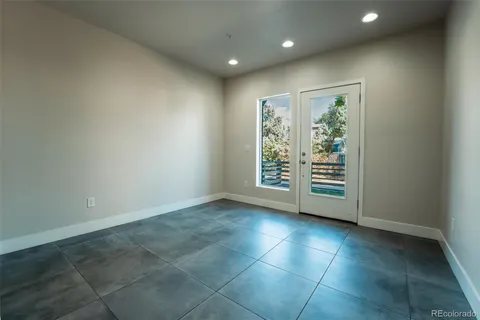 an empty room with windows and closet