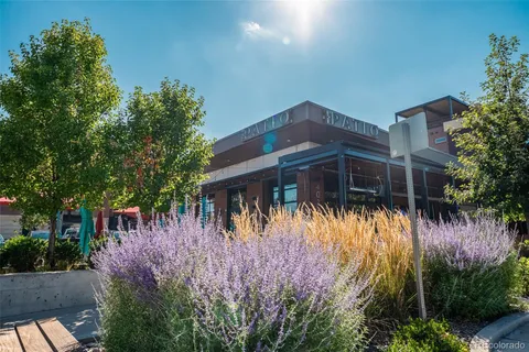 a front view of a house with a yard and fountain in middle