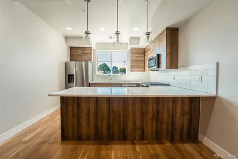 a kitchen with a wooden floor and a sink