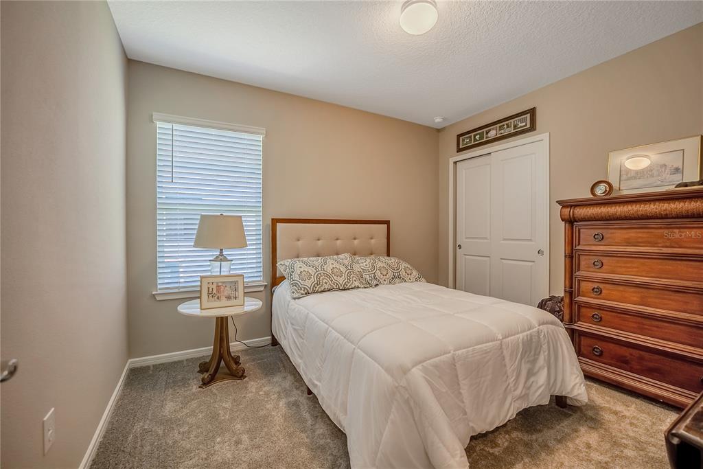 8344 Southwest 54th Loop Ocala, FL 34481 - Photo 16 of 36 a bedroom with a bed and a window