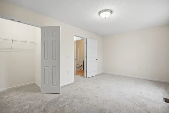 an empty room with closet area