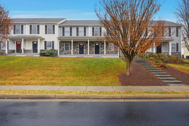 a front view of a residential apartment building with a swimming pool